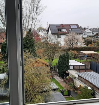 geöffnetes Fenster mit Blick in den Garten